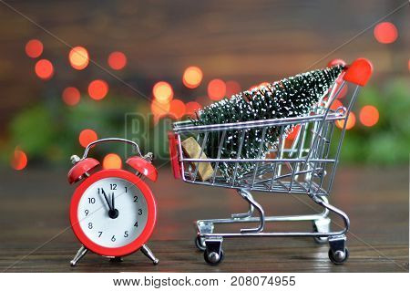 Shopping cart with Christmas tree and alarm clock