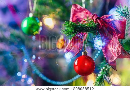 Bright Christmas and New Year background. Christmas and New Year decorations background. Red christmas shiny ball on fir branch.