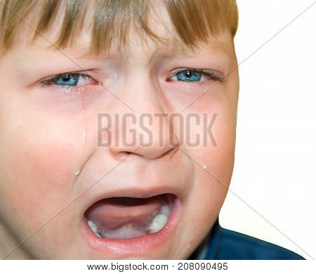 little boy was crying from hurt tears stream down cheeks. emotion child sadness. kid cry isolated on white background