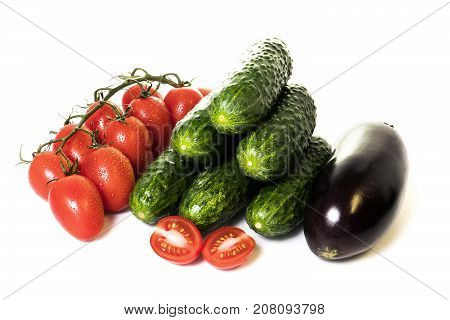 vegetables cucumbers and tomatoes on a white background