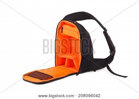 Outdoor backpack for camera isolated on white background. Outside is black, inside is orange. Close-up.
