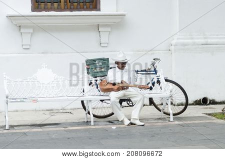 VERACRUZ, MEXICO- SEPTEMBER 27, 2017: Musician dressing with traditional jarocho clothes resting on a bench at the street in Veracruz, Mexico