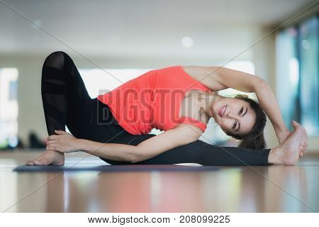 Asian lady post diffical lavel yoga action and sit on the flor of fitness center health sport relax fitness and yoga concept