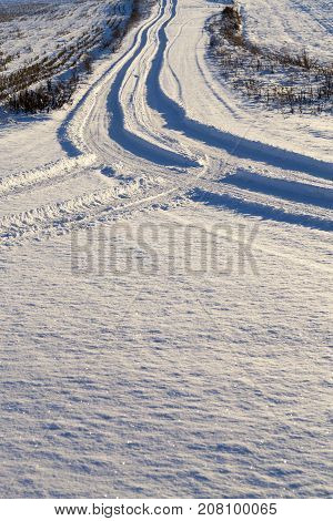 snow-covered road in the winter season. Close-up photo