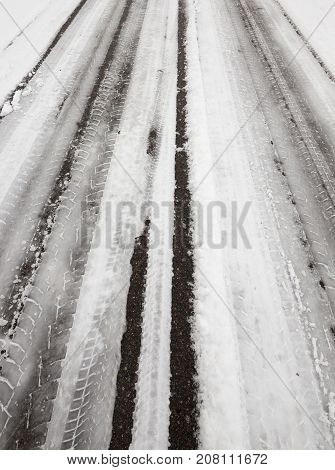 Ruts On The Road From Cars. The Territory Is Covered With Snow In The Winter Season. Photo Taken Clo
