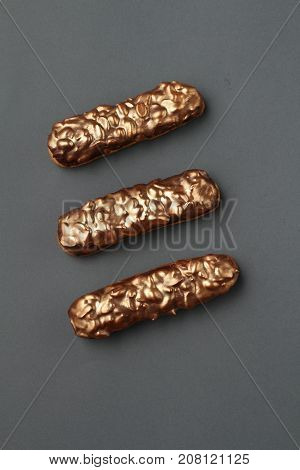 chocolate golden eclairs with caramel, peanuts, and chocolate icing