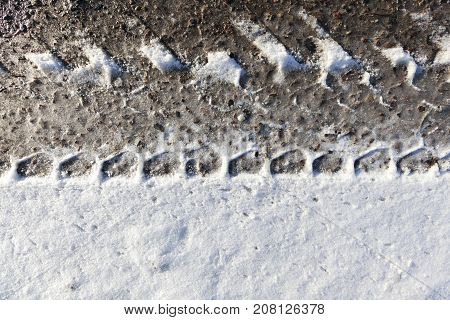 Close-up Photo Of A Road In The Winter Season. On The Snow, You Can See The Rut And The Protector Of