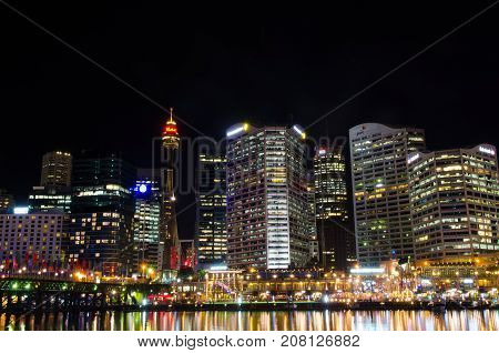 SYDNEY AUSTRALIA - AUGUST 2017 : View of Sydney city skyline at night near Pyrmont Bridge Cockle Bay Wharf in Sydney Australia on August 14 2017.