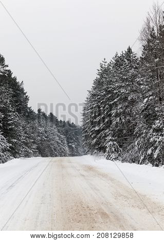 A Snow-covered Road In The Winter Season. Close-up Photo