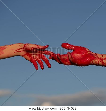 zombie hands male and female of man war soldier and girl or woman with bloody wounds and red blood on skin on blue sky background