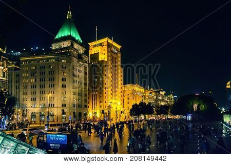 Shanghai, China - Nov 4, 2016: Night view of Sassoon House and Bank of China buildings (left to right) along The Bund on Zhongshan East 1st Road. Some haze can still be seen.