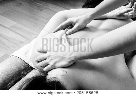 Physiotherapist, Chiropractor Giving A Massage And Stretching Of Subscapularis And Rhomboid To A Pat
