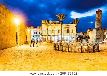 Night photo of street with Ribat castle in Sousse. Medieval architecture in night lights. Vivid picture of ancient religious building - one of the main attractions in Sousse, Tunisia.