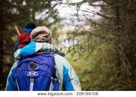 Tourists walking along the river Bank in autumn day