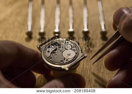 Watchmaker is repairing the mechanical watches in his workshop