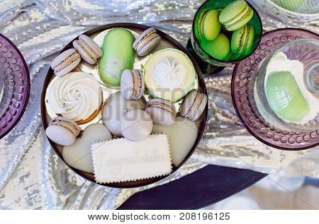Pile of colorful macaron cookies vintage style on colourful plates