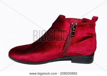 Lady's red velvet ankle boots isolated on white background.