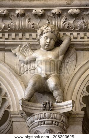 Stone sculpture of Angel on the wall of new chapel in Trogir Cathedral of saint Lawrence