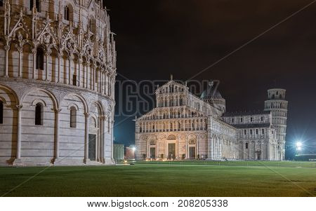 PISA, ITALY - SEPTEMBER 19, 2014: The world famous Piazza dei Miracoli by night in Pisa, Tuscany.  The construction of the cathedral was begun in 1064.