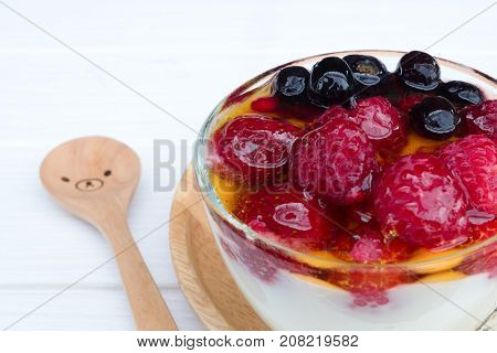 Yogurt, fruit and strawberry, raspberry, blueberry on old wood floor