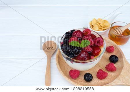 Yogurt, fruit and strawberry, raspberry, blueberry on old wood floor