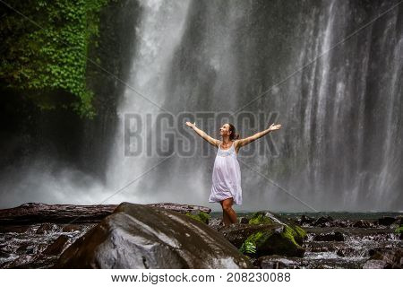 Woman Meditating Doing Yoga Between Waterfalls