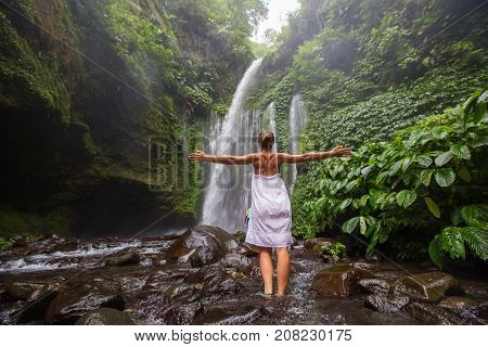 Woman Meditating Doing Yoga Between Waterfalls