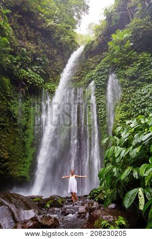 Woman Meditating Doing Yoga Between Waterfalls