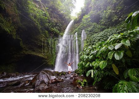 Woman Meditating Doing Yoga Between Waterfalls