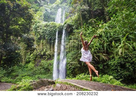 Woman Meditating Doing Yoga Between Waterfalls