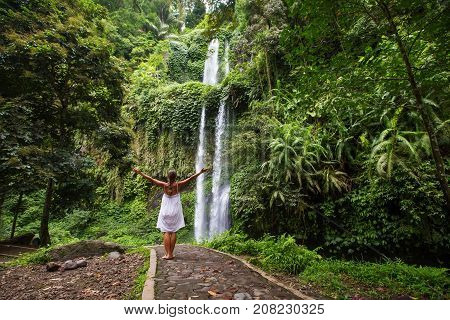 Woman Meditating Doing Yoga Between Waterfalls