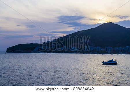 Sea view evening. Soltsev descended the hill. The ship is in the roadstead. Montenegro. Budva