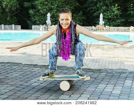 Girl On Oval Wooden Deck For Balance Board. Plastic Roller For Balance Board. Rocker-roller Boards.