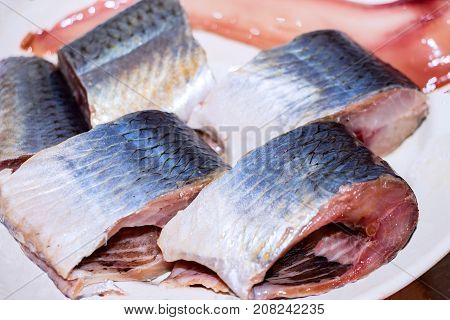 Pieces of fish, Pieces of herring on the plate. Selective focus