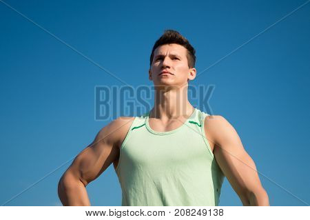 Man Bodybuilder Posing On Blue Sky