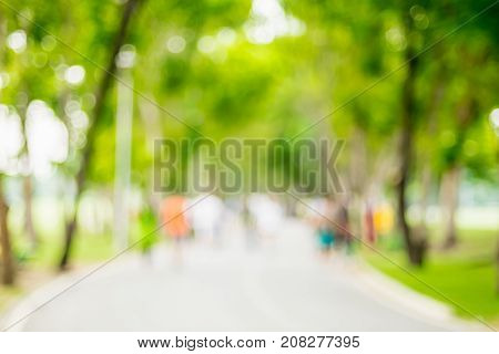 Blurred Background,people Exercise At Green Park With Bokeh Light. Healthy Lifestyle Concept