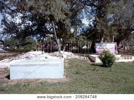 NUKU'ALOFA / TONGA - CIRCA 1990: Graves in a cemetery in Nuku'alofa, on the island of Tongatapu, are decorated with tapestries and other items.