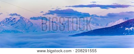 Scenic panorama sunset landscape of Crans-Montana range in Swiss Alps mountains with peak in background, Crans Montana, Switzerland.