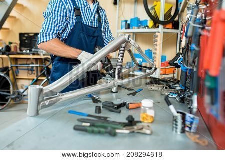Workplace of repairman with master of bicycle repair drilling metallic detail