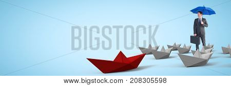 Digital composite of Busnessman with umbrella surrounded by 3d paper boats