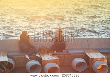 SYDNEY AUSTRALIA - August 16 2017: Unidentified people dine at opera barwaterfront restaurant during sunset.