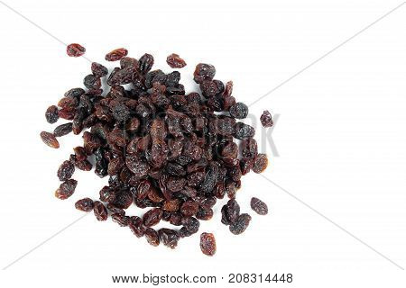 black raisins isolated on white and wooden background