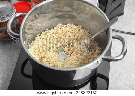 Stewpot with boiled rice in kitchen