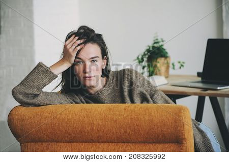 indoor portrait of beautiful feminine thoughtful young women alone in the room.