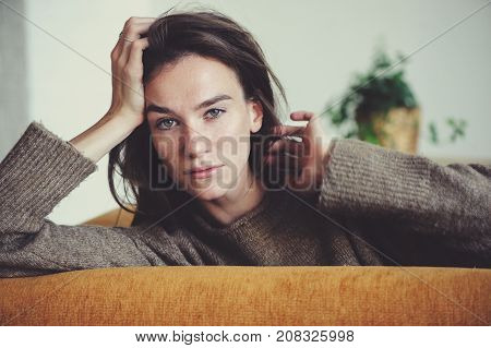 indoor portrait of beautiful feminine thoughtful young women alone in the room.