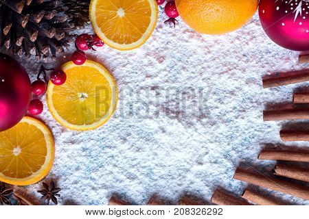 Orange Cinnamon cone red ball. Christmas winter background.