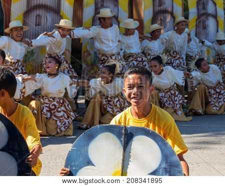 Dumaguete Philippines - 16 September 2017: Sandurot Festival of Dumaguete. Carnival with dancing in colorful costumes. Smiling boy actor in street performance. Philippines people in traditional wear