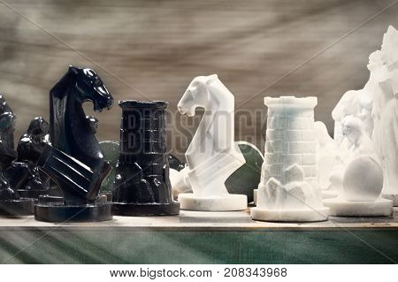 Black and White chess setup on light background . Leader and teamwork concept for success