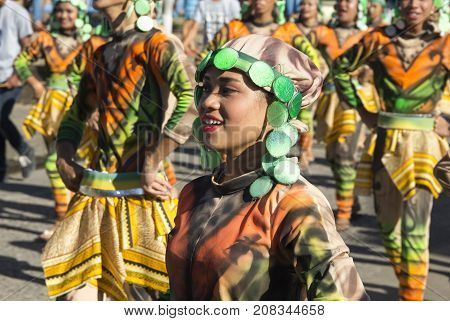 Dumaguete Philippines - 16 September 2017: Sandurot Festival actor in national clothes. Carnival street dancer in colorful costumes. Smiling people on traditional autumn parade. Philippines festival