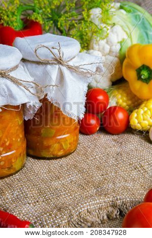 jars with winter supplies, banks with salad are on the table with vegetables